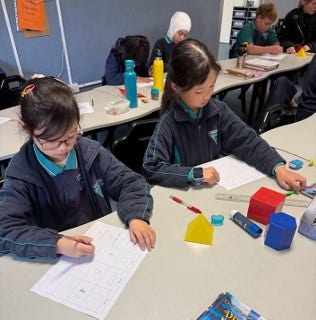 Student working with 3D shapes
