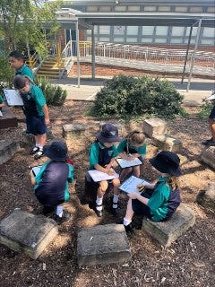 Group of students learning in the outdoor Yarning circle